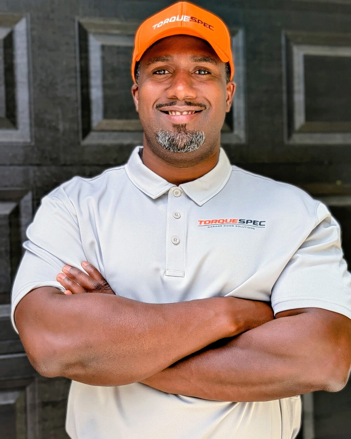 TorqueSpec Garage Door Solutions owner in branded hat and polo